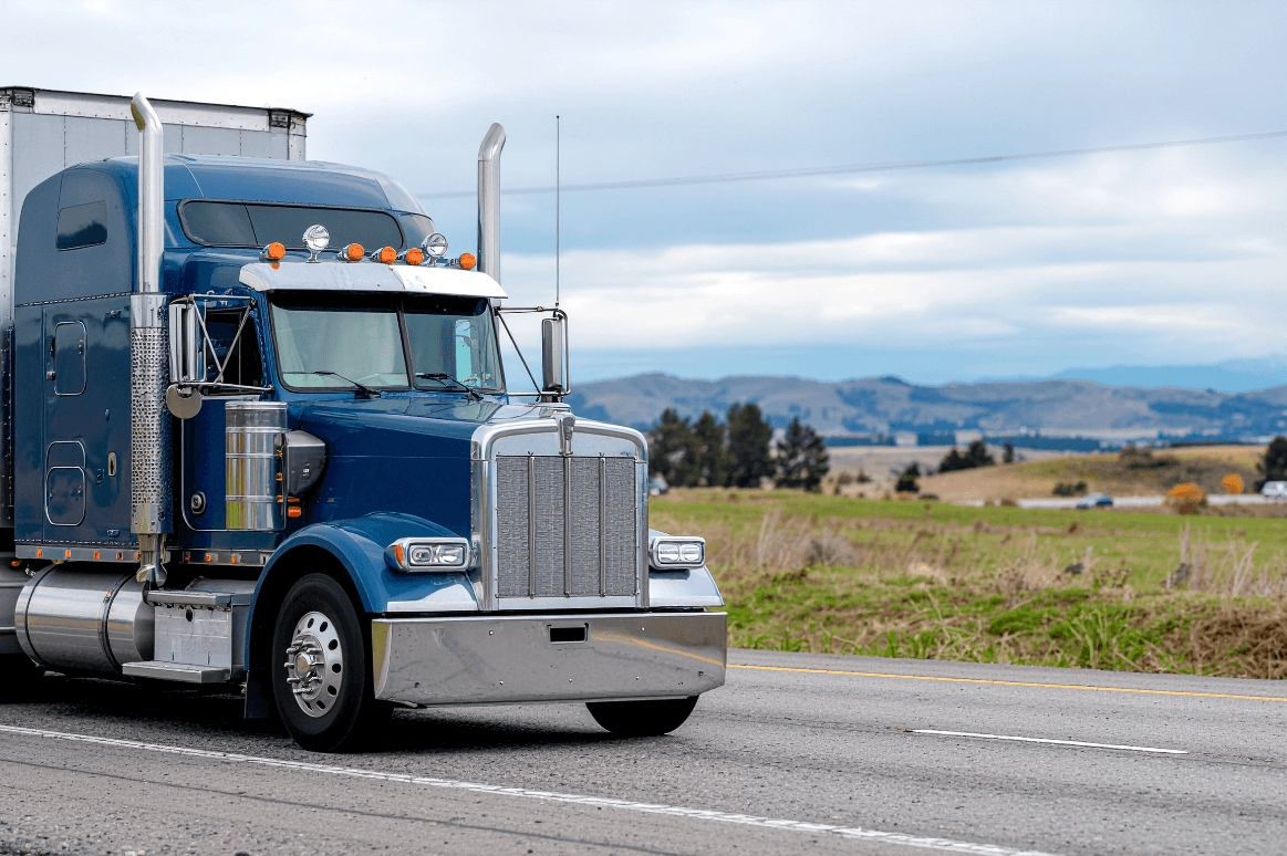 Green semi truck on a highway